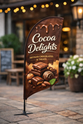 Promotional crest advertising flag for a fictional chocolate brand “Cocoa Delights,” featuring rich brown chocolate-drip design, artisan chocolates imagery, and elegant typography, displayed outside a cosy café setting.